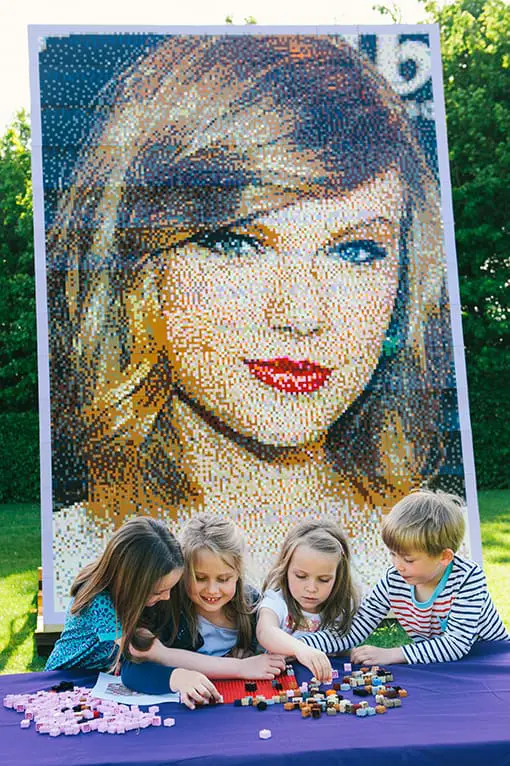 Giant Lego Mosaic of 'Celebrity Best Friend' Taylor Swift revealed at The Legoland Windsor Resort on May 25, 2015 in Windsor, England.  Children helping out to create the mosaic to celebrate the opening of Heartlake City, a brand new LEGO Friends themed area.  